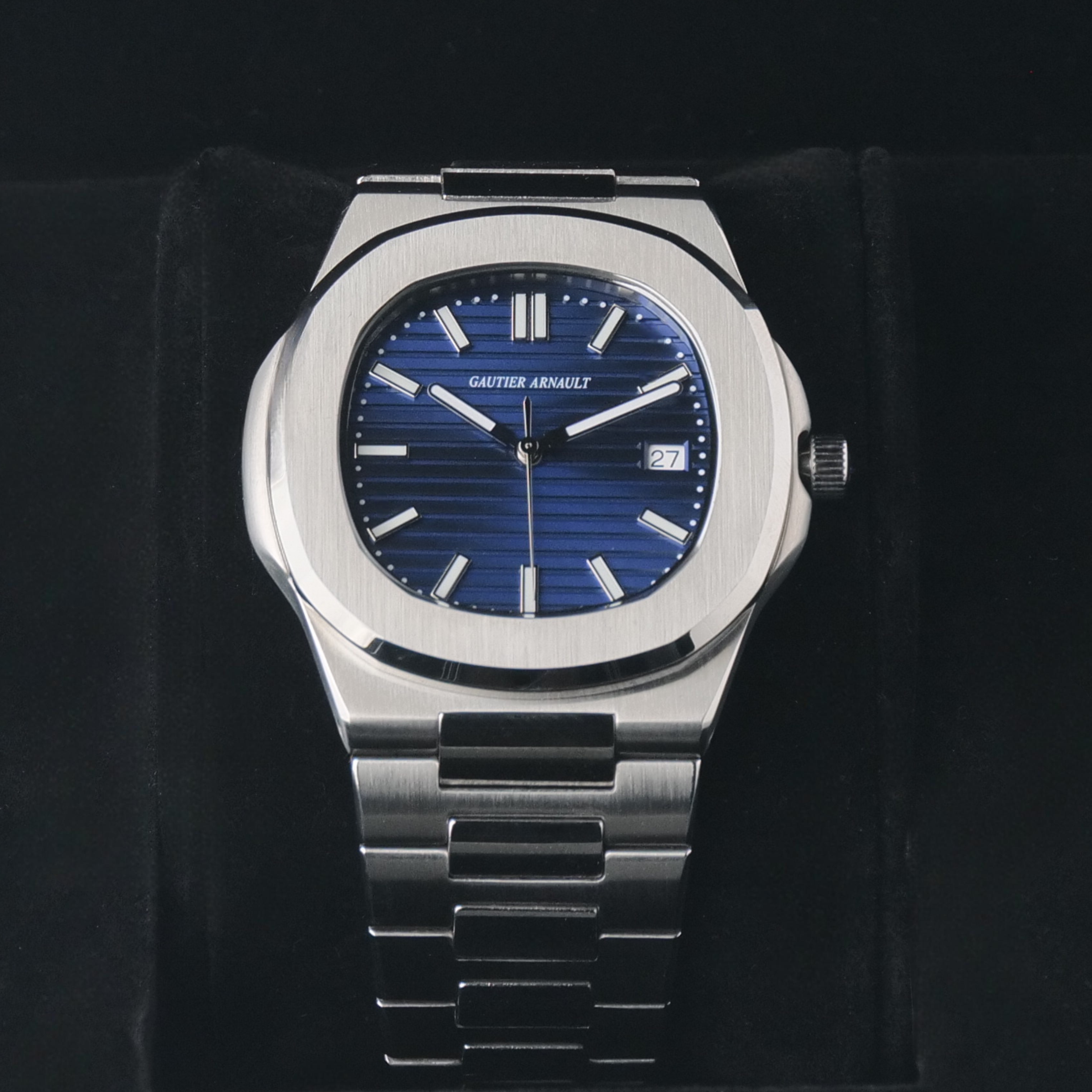 Silver watch with blue dial on a black background
